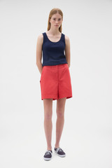 Profile view of model wearing the Oroton Flat Front Carpenter Short in Robbin Red and 100% cotton fabric for Women .