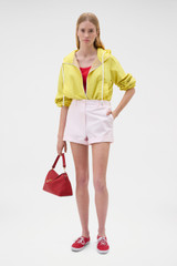 Profile view of model wearing the Oroton Flat Front Carpenter Short in Perfect Pink and 100% cotton fabric for Women .