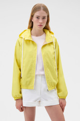 Profile view of model wearing the Oroton Weekend Windbreaker in Daffodil and 100% cotton fabric for Women .
