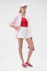 Profile view of model wearing the Oroton Oxford Stripe Shirt in Perfect Pink and 100% cotton fabric for Women .