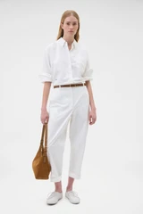 Profile view of model wearing the Oroton Oxford Shirt in Antique White and 100% cotton fabric for Women .