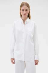 Profile view of model wearing the Oroton Oxford Shirt in Antique White and 100% cotton fabric for Women .