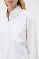 Profile view of model wearing the Oroton Oxford Shirt in Antique White and 100% cotton fabric for Women .