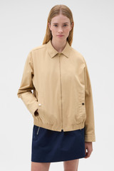 Profile view of model wearing the Oroton Drill Bomber in Praline and 100% cotton fabric for Women .