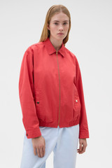 Profile view of model wearing the Oroton Drill Bomber in Robbin Red and 100% cotton fabric for Women .