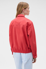 Profile view of model wearing the Oroton Drill Bomber in Robbin Red and 100% cotton fabric for Women .