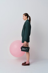 Profile view of model wearing the Oroton Pleated Bomber Shirt in Neptune Green and 100% cotton poplin fabric for Women .
