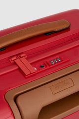 Detail product shot of the Oroton Jet Carry On Roller Case in Dark Ruby and Durable polycarbonate shell for Women .