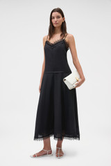 Profile view of model wearing the Oroton Lace Trim Sundress in Black and 100% ramie fabric for Women .