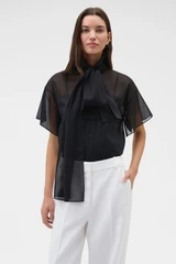 Profile view of model wearing the Oroton Scarf Detail Top in Black and 100% cotton voile fabric for Women .