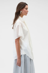 Profile view of model wearing the Oroton Scarf Detail Top in Antique White and 100% cotton voile fabric for Women .