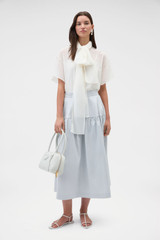 Profile view of model wearing the Oroton Scarf Detail Top in Antique White and 100% cotton voile fabric for Women .