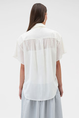 Profile view of model wearing the Oroton Scarf Detail Top in Antique White and 100% cotton voile fabric for Women .