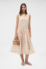 Profile view of model wearing the Oroton Sheer Check Drop Waist Dress in Butterscotch and 80% cotton and 20% lightweight silk blend fabric for Women .