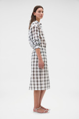 Profile view of model wearing the Oroton Sheer Check Pencil Skirt in Graphite and 80% cotton and 20% lightweight silk blend fabric for Women .