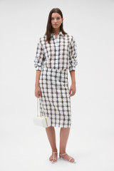 Profile view of model wearing the Oroton Sheer Check Pencil Skirt in Graphite and 80% cotton and 20% lightweight silk blend fabric for Women .