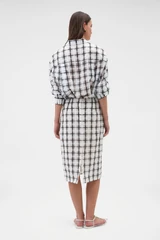 Profile view of model wearing the Oroton Sheer Check Pencil Skirt in Graphite and 80% cotton and 20% lightweight silk blend fabric for Women .