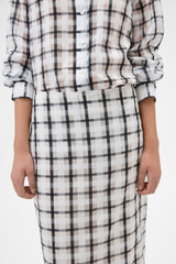 Profile view of model wearing the Oroton Sheer Check Pencil Skirt in Graphite and 80% cotton and 20% lightweight silk blend fabric for Women .