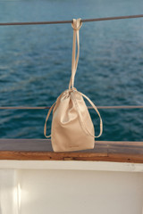 Detail product shot of the Oroton Maple Satin Mini Bag in Peach and Satin fabric material for Women .