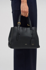 Profile view of model wearing the Oroton Margot Mini Day Bag in Black and Pebble Leather for Women .