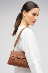 Profile view of model wearing the Oroton Margot Small Top Handle in Whiskey and Premium pebble leather for Women .