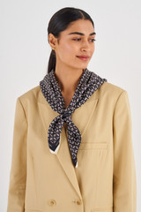 Profile view of model wearing the Oroton All Over Logo Silk Scarf in Black and 100% Silk for Women .