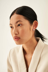 Profile view of model wearing the Oroton Phoebe Small Sleeper in Silver/Crystal and Brass Base With Rhodium Plating for Women .