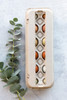 Closed blank 12-Egg View Style Paper-Pulp Carton filled with multi-colored eggs and surrounded by green leafy plants