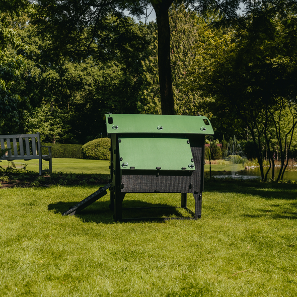 Side view of large lodge coop that holds up to 8 hens on a grassy yard