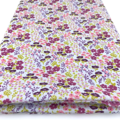 Delightful small flowers in  many summery colours printed on sky polycotton fabric.