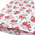 Hot and pale pink rose flower on white polycotton fabric with green foliage and tiny blue flowers.