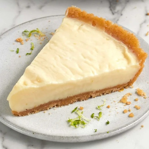 Slice of Florida Fresh Key Lime Pie with creamy Key lime filling, buttery graham cracker crust, and fresh lime zest garnish served on a dessert plate.