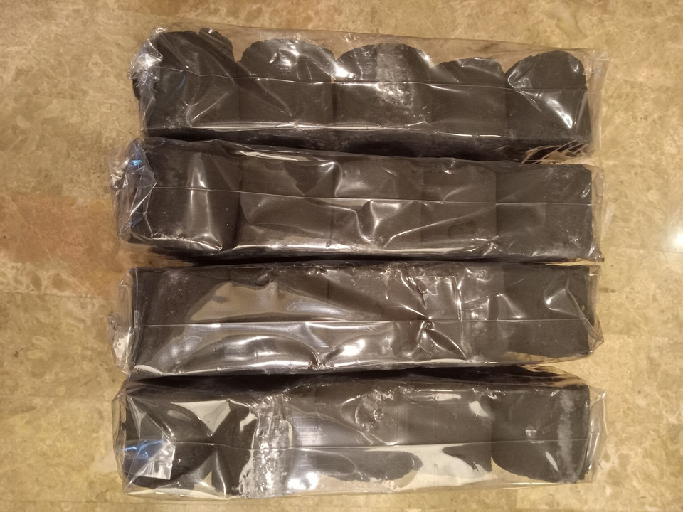 Four wrapped packs of COCO-BBQ coconut shell charcoal