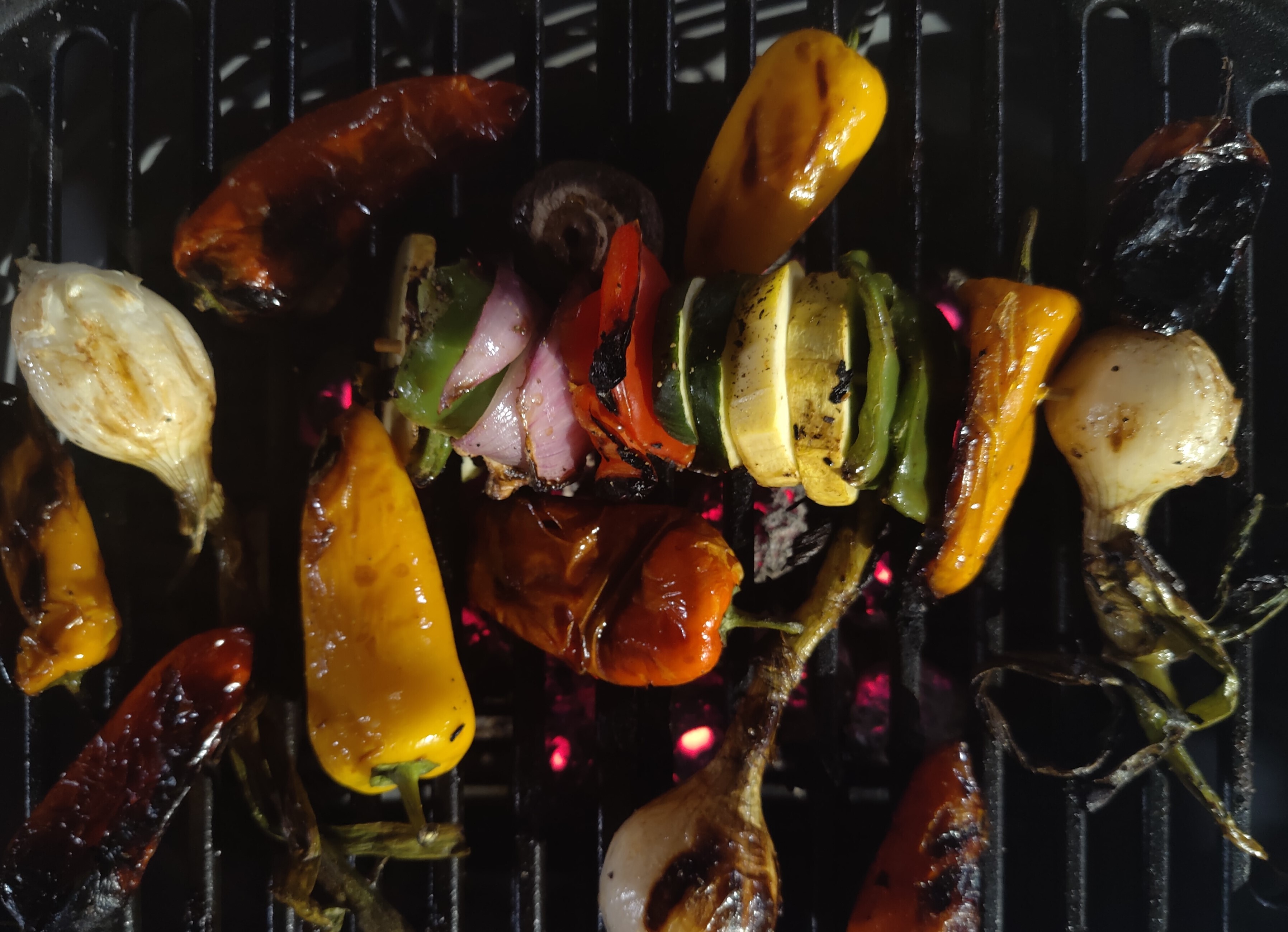 Charred vegetable skewers on the grill