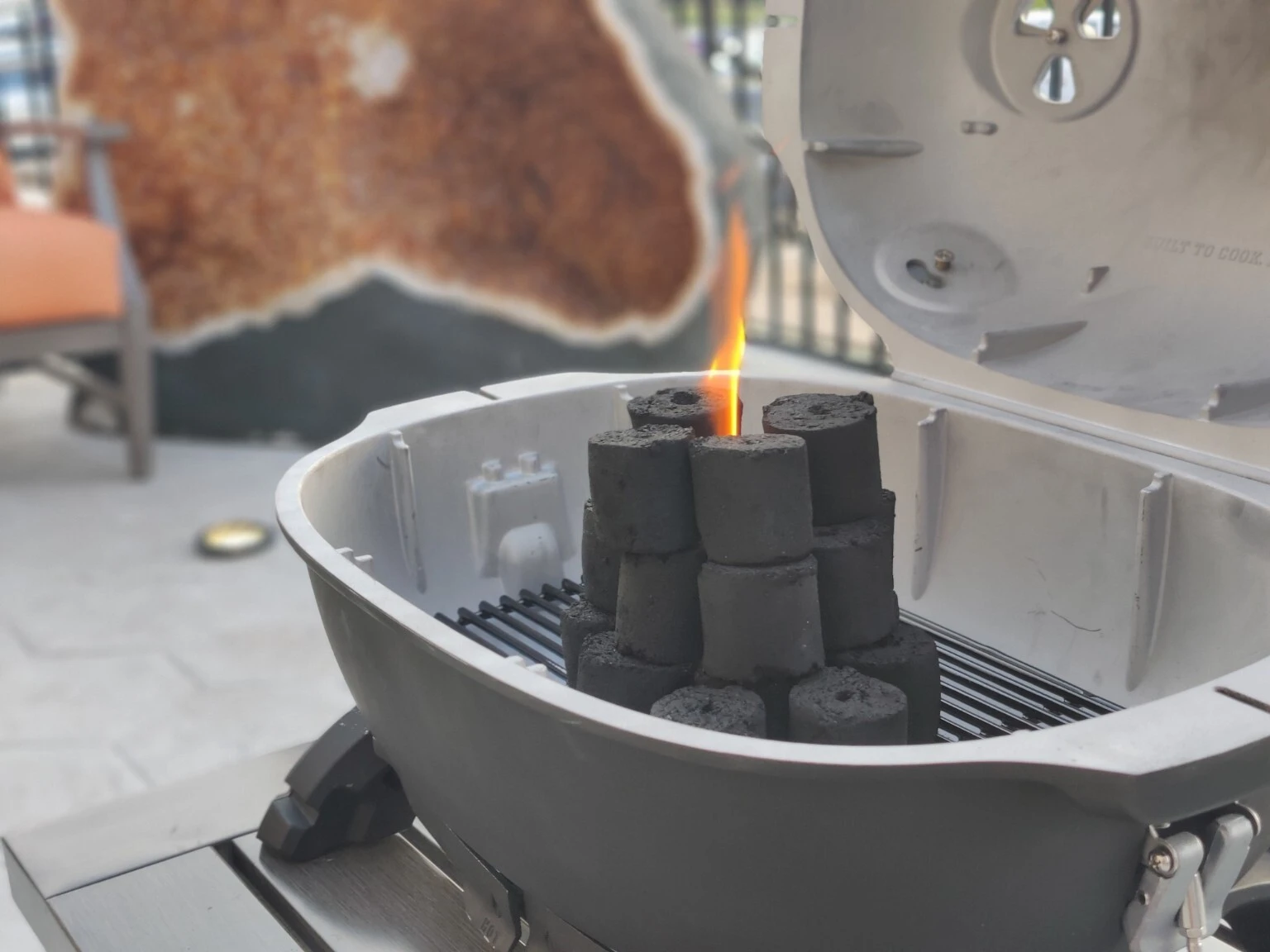Cylindrical charcoal arranged for lighting in a kettle barbecue