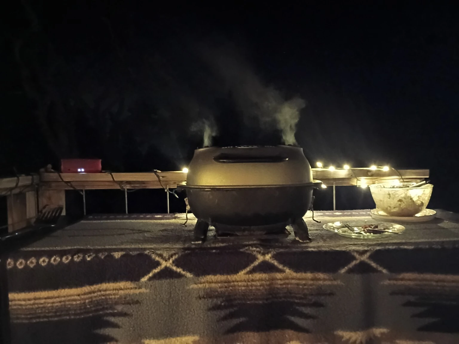 Outdoor barbecue on a patio after dark