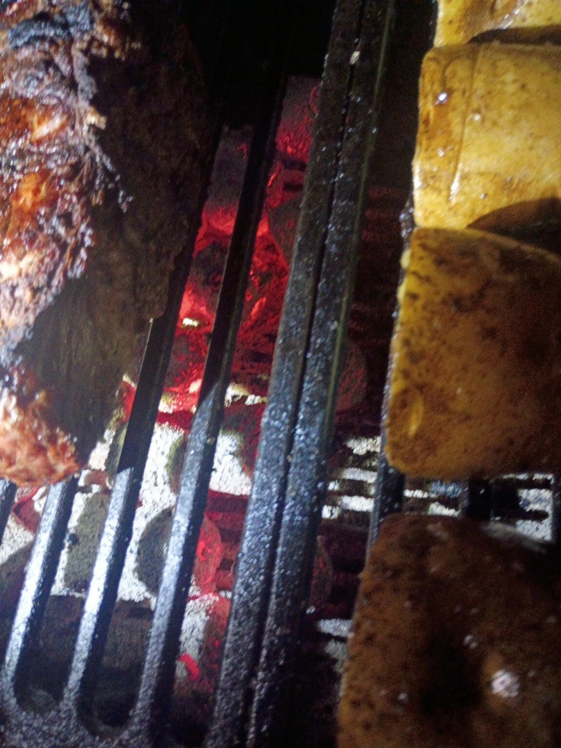 Food grilling over glowing COCO-BBQ coconut shell charcoal