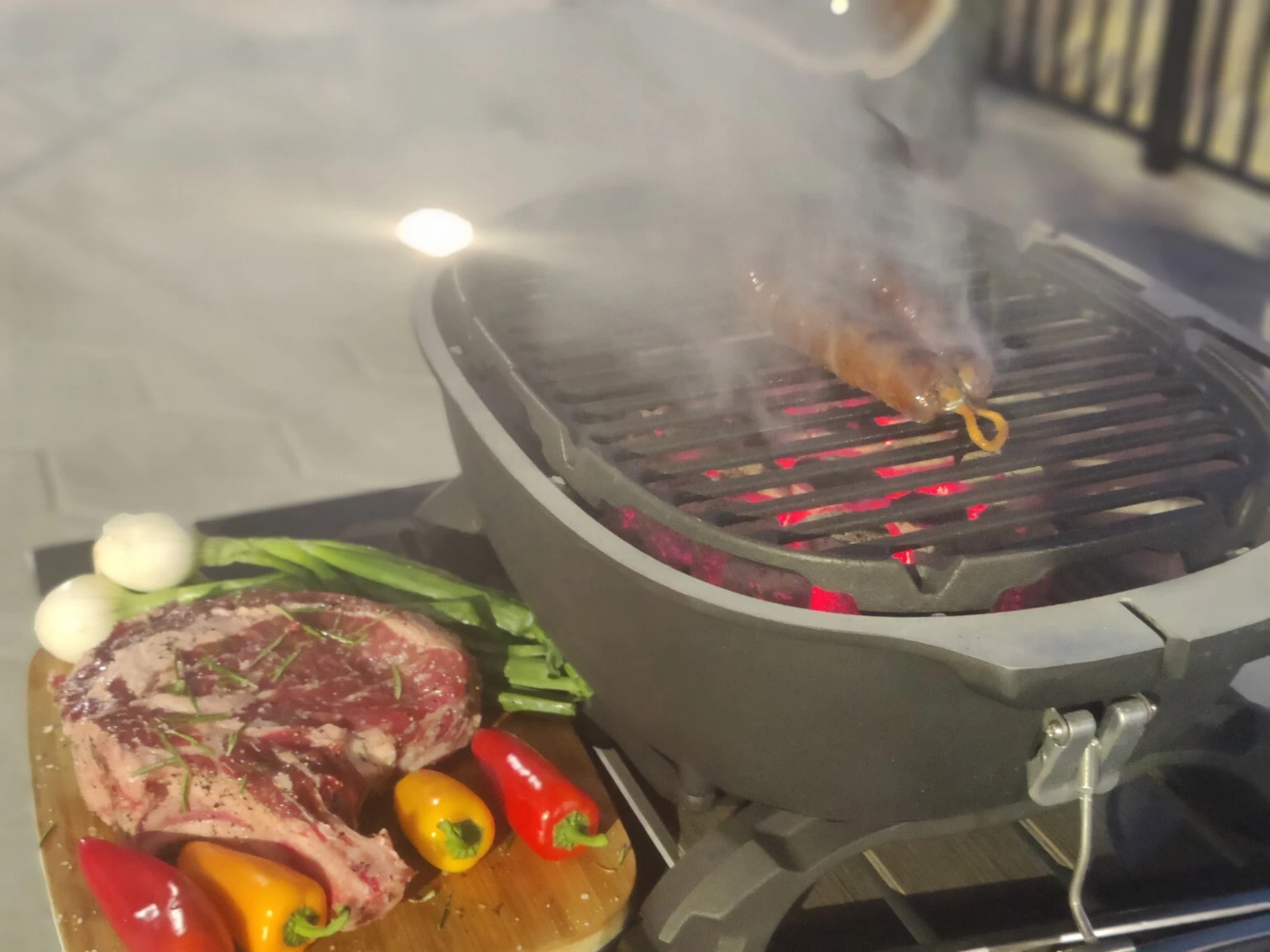 Steak, vegetables and glowing charcoal ready for an outdoor cookout