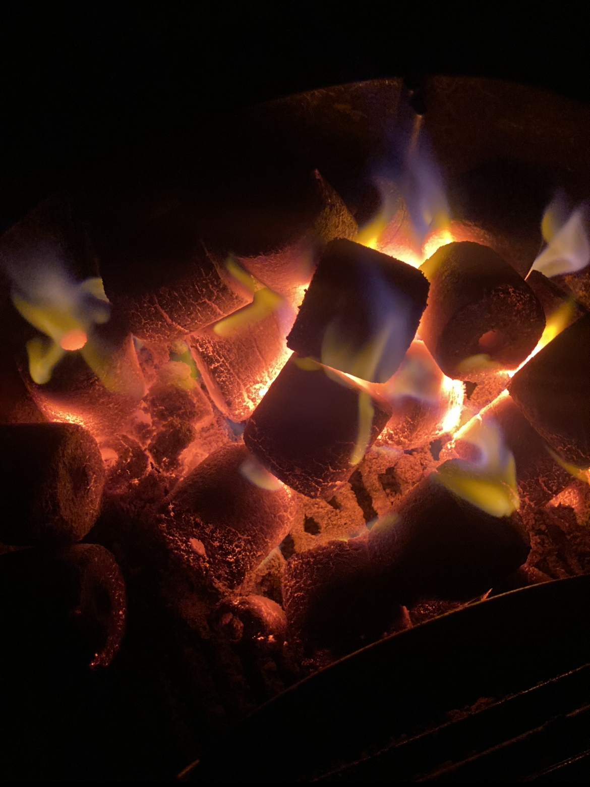 Close up of glowing Coco-BBQ coconut shell charcoal embers