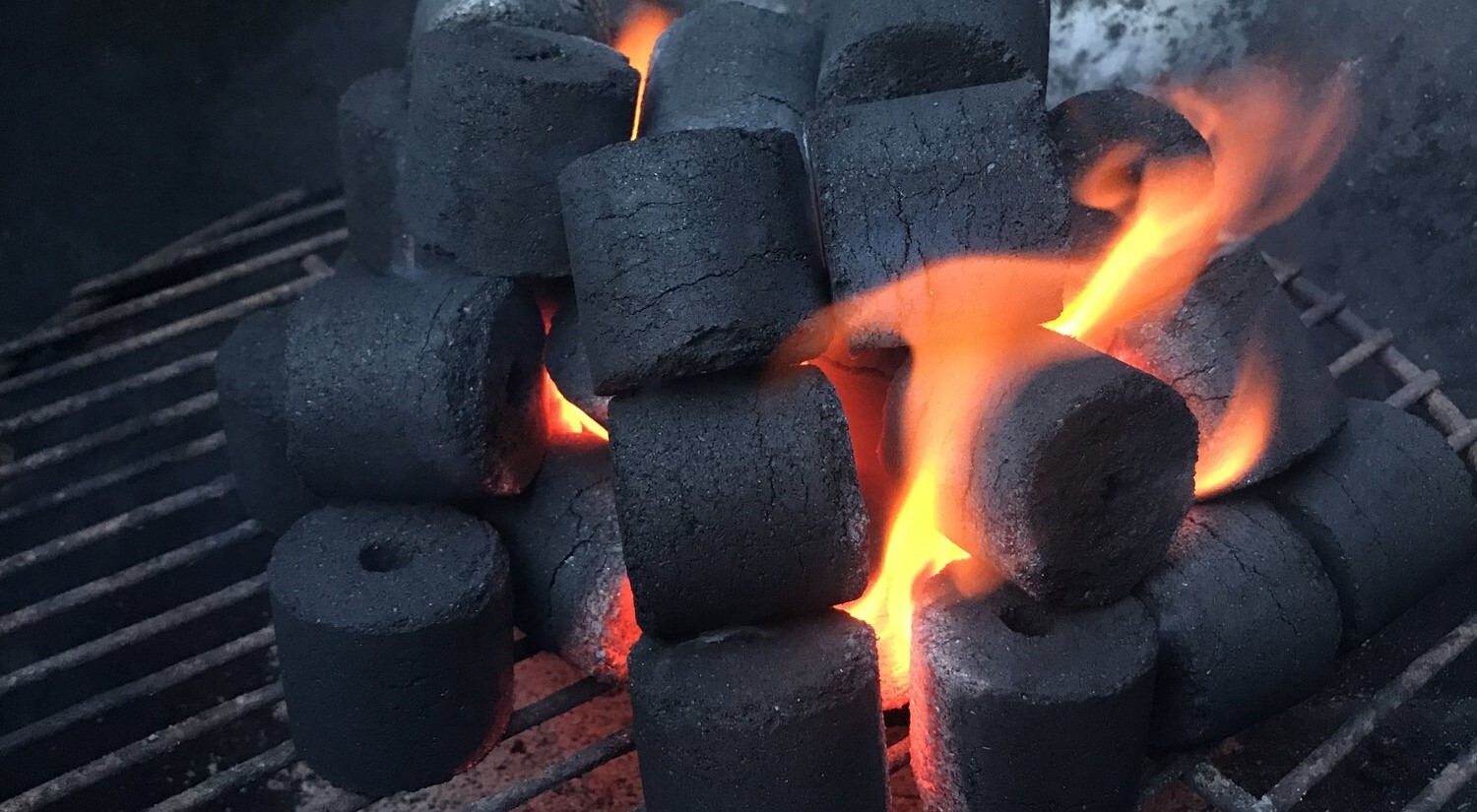Vegetables grilling over glowing Coco-BBQ coconut shell charcoal