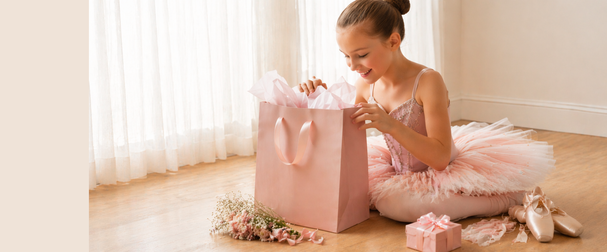 Young ballerina opening a pink gift bag