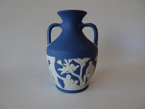 Vintage Wedgwood dark blue jasperware portland vase decorated with classical roman scenes and in original box.