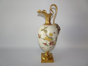 Antique Royal Worcester porcelain ewer dated 1888 with hand-painted yellow blossoms, autumn foliage, gilt pinched spout, classical mask handle and square base.