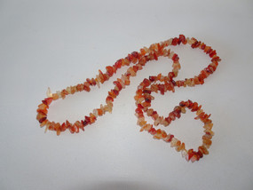 Vintage carnelian chip necklace displaying rich orange and amber gemstone chips.