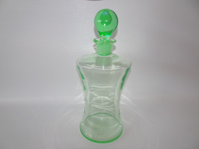 Antique uranium glass waisted decanter with green stopper measuring 27cm tall