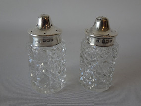 Pair of sterling silver and cut crystal shakers by George Edwin Walton Birmingham 1908