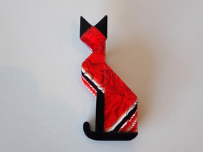 Vintage Lea Stein Paris Deco Cat brooch in pearlescent red with black and white swirl design