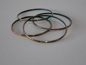 Set of four vintage Chinese cloisonné enamel bangles with multicoloured floral decoration and turquoise blue enamel interiors.