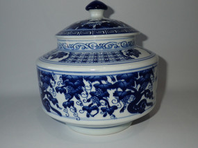 Vintage Chinese blue and white porcelain covered jar decorated with traditional grapevine motifs and matching domed lid.