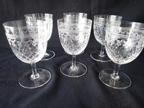 Set of six Edwardian Pall Mall Lady Hamilton cut crystal wine glasses with floral bands and cross-hatched cut decoration.